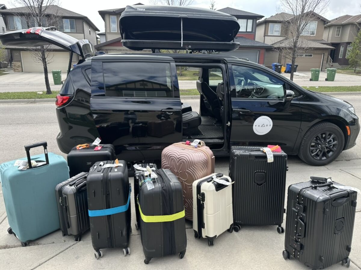 Airport shuttle luggage capacity — 12 suitcases plus Thule rooftop cargo box